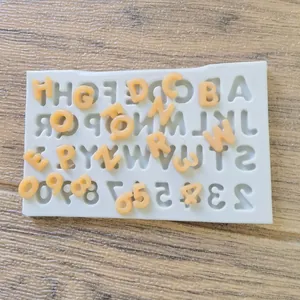 Macro detail view of white silicone alphabet and number mold for DIY cake decorating