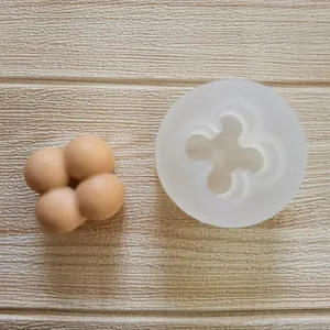 Detailed side-by-side view of a 4-ball balloon silicone mold and its finished clay piece