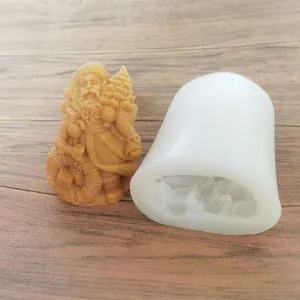 Detailed view of Santa Claus silicone mold and finished wax figure on a wooden background