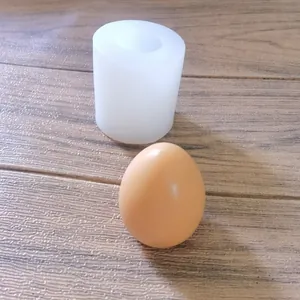 Detailed view of a 3D egg-shaped silicone mold on wood background with finished sample