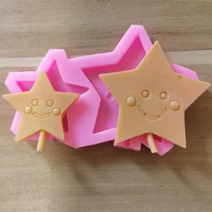 Close-up detail of pink silicone mold with star smiley face shapes for DIY cookie baking