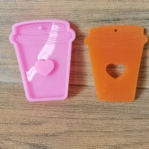 Close-up detail of coffee cup shaped silicone resin mold with heart pattern casting