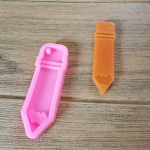 Pencil shaped silicone mold shown next to its finished resin casting result