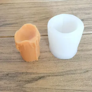 Καλούπι σιλικόνης για κερί δακρύων DIY με δείγμα πορτοκαλί κεριού σε ξύλινη επιφάνεια