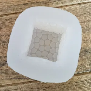 Close-up showing the intricate internal honeycomb texture of a square silicone mold