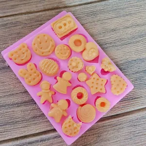 Close-up of pink silicone mold with donut and gingerbread man shapes for DIY baking.