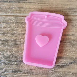 Close-up detail of pink silicone milk tea cup mold with a cute heart for DIY resin crafts