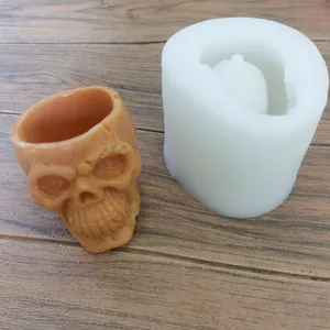 Detailed view of 3D skull silicone mold with a finished terracotta skull candle holder