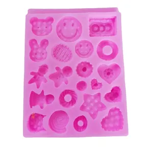 Pink silicone mold featuring gingerbread man, heart, and donut shapes for DIY cake decorating.