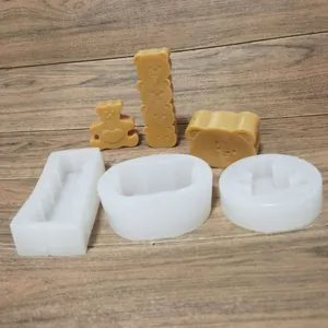 Set of three cute bear silicone molds for candles and chocolate on a wooden table