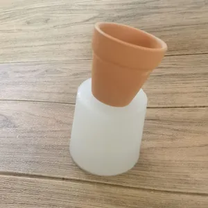Detail showing a white silicone mold for making succulent flower pots on wood floor