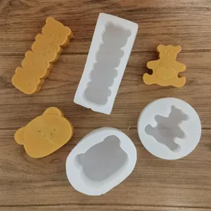Detailed view of various bear-shaped silicone molds for candle and soap making