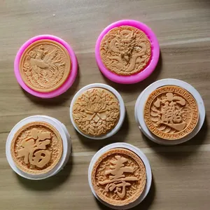 Detail view of Chinese style silicone molds for fondant with dragon and phoenix designs