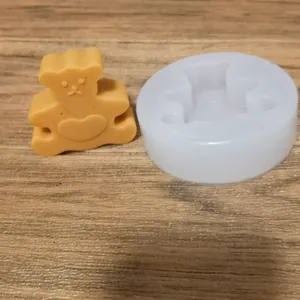 Detail view of the cute bear silicone mold alongside a finished aromatherapy wax bear
