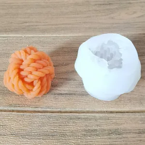 Detailed view showing wool ball shaped silicone mold and orange finished candle texture.