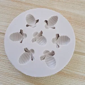 Detailed view of a 7-cavity bee-shaped silicone mold for fondant and chocolate decor