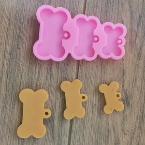 Vista dettagliata di uno stampo in silicone a 3 cavità a forma di osso per ciondoli in resina.