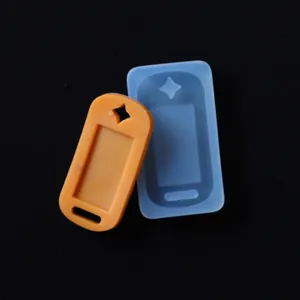 Dettaglio di uno stampo in silicone blu e di un ciondolo in resina arancione per DIY