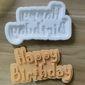 Close-up detail showing the white silicone mold and Happy Birthday fondant cake topper lettering.