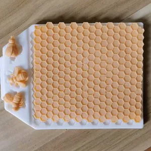 Macro view of honeycomb texture and bee shapes in a white silicone baking mold