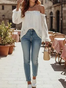 Full view of the elegant white lace off-shoulder blouse in a stylish outdoor setting
