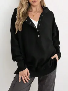 Gros plan sur un sweat à capuche noir côtelé pour femme avec col Henley boutonné élégant