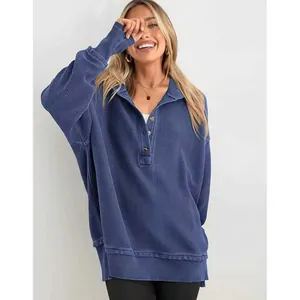 Détail d'un sweat-shirt en coton côtelé bleu oversize avec un col polo boutonné classique