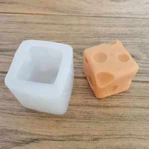 Detailed view of square dice cheese silicone mold with finished orange resin product
