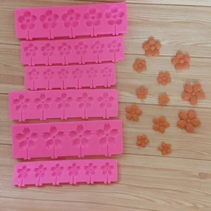 Macro detail of various pink silicone flower molds for chocolate and fondant cake decorating