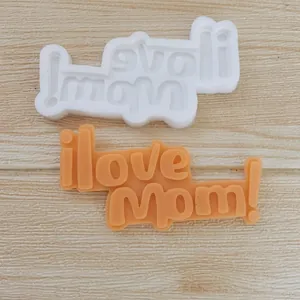 Detailed macro view showing the 'I love Mom!' silicone mold and its orange fondant topper