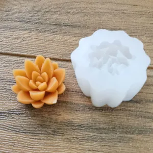 Macro detail of white succulent silicone mold and a finished orange floral candle