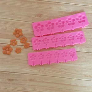 Detailed view of pink flower silicone molds for daisy-shaped lollipops and fondant cakes