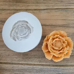 Top-down view of a white flower silicone mold with a finished orange aromatherapy flower