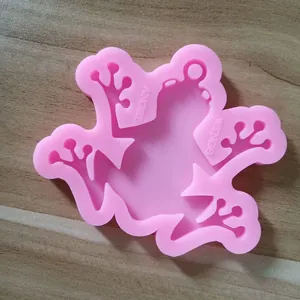 Macro view of a pink frog-shaped silicone mold with Angel Wings text for resin DIY crafts