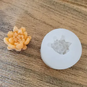 Detail macro shot of white succulent flower silicone mold with finished yellow wax craft