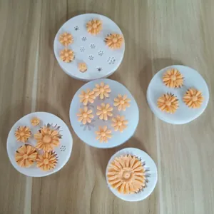 Multiple daisy flower silicone molds for fondant and chocolate cake decorating.