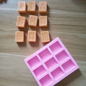 Mahjong tile silicone mold detail with molded orange chocolate pieces on wooden surface