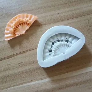 Detailed macro view of a classical fan-shaped silicone mold with a finished sample