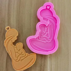 Close-up detail of a pink silicone mother and child mold with a finished resin piece