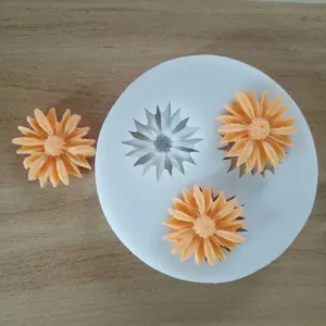 Macro detail view of daisy flower silicone mold with orange fondant decorations