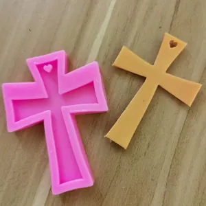 Detail of cross-shaped silicone mold with heart hole for resin or fondant crafting