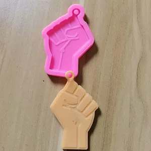 Detailed view of raised fist shaped silicone mold for DIY resin keychain casting