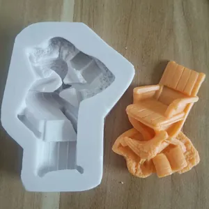 Detailed macro view of 3D chair silicone mold with an orange fondant finished result