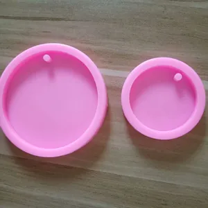 Detail view of large and small round pink silicone molds for DIY crafts and keychains