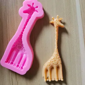 Detailed view of pink silicone giraffe mold and finished cartoon fondant decoration