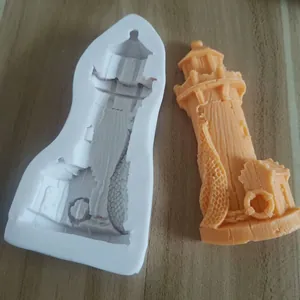 Detailed view of lighthouse silicone mold and orange finished nautical cake decoration