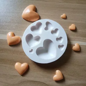 Detailed view of white circular silicone mold with various heart-shaped cavities