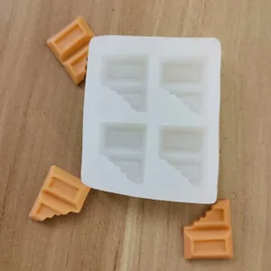 Detail shot of white silicone chocolate mold with bitten bar design and orange wax melts