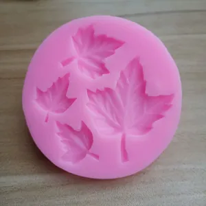 Detailed view of pink silicone mold with four different sizes of maple leaf shapes