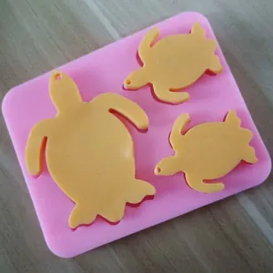 Detailed view of a 3-cavity turtle-shaped pink silicone mold for resin or clay crafting